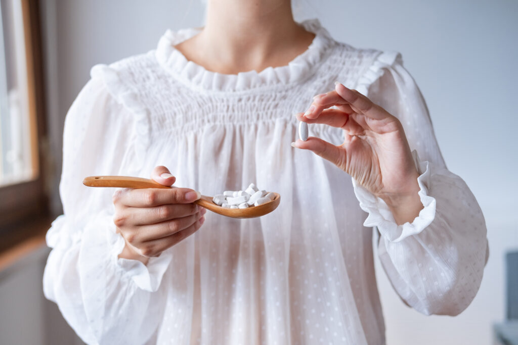 Photo of woman holding magnesium supplement