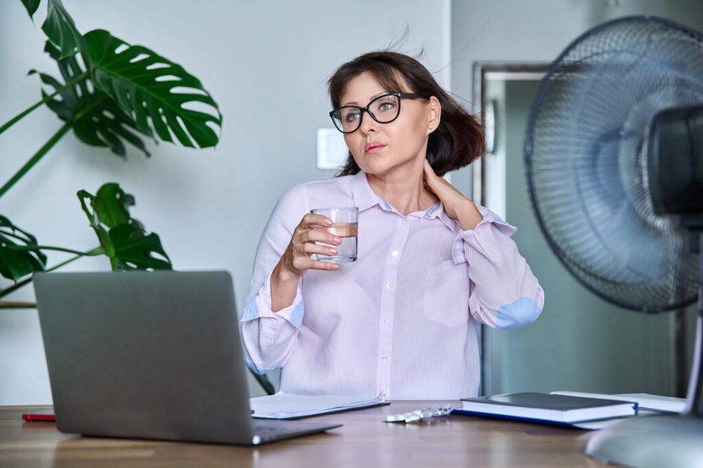 Photo of woman looking stressed at her desk working