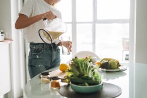 Photo of woman in kitchen preparing protein shake