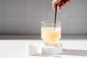 Photo of woman stirring a supplement into glass