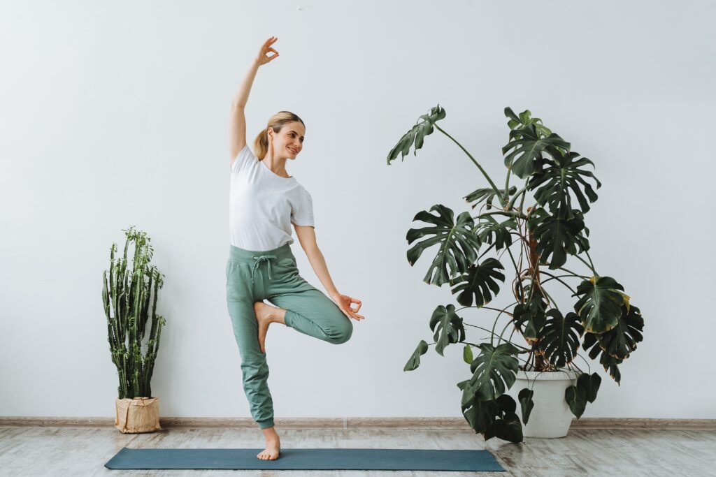 Photo of woman balancing on one leg doing yoga