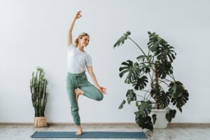 Photo of woman balancing on one leg doing yoga