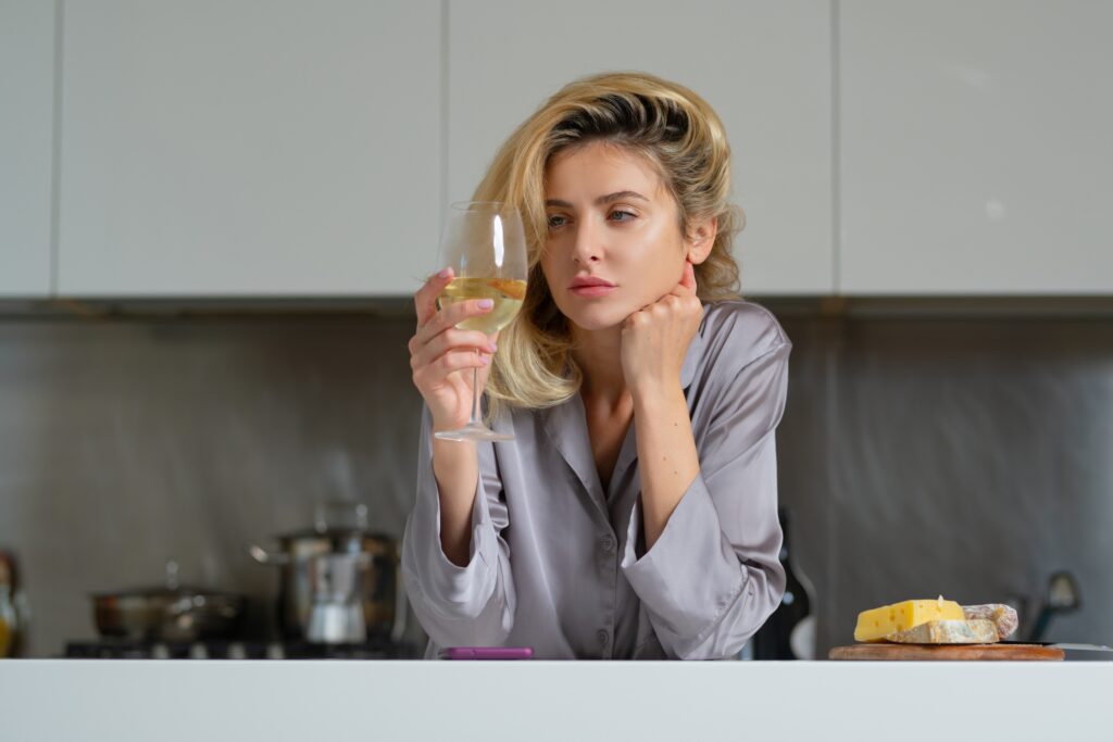 Photo of unhappy woman drinking alcohol