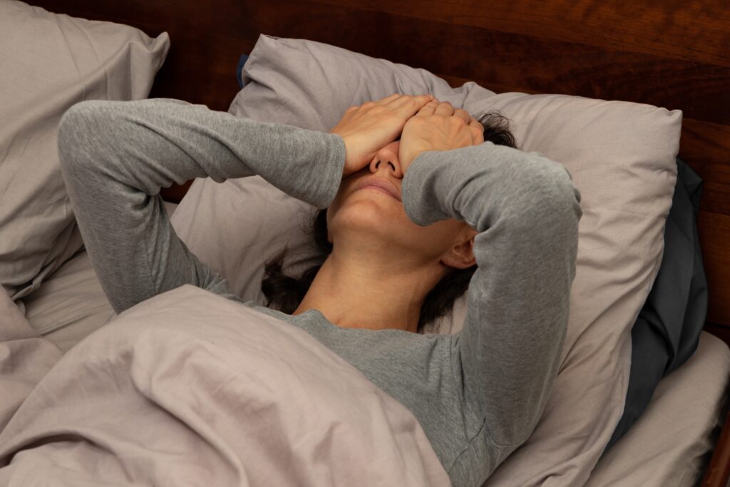 Photo of woman in bed looking tired